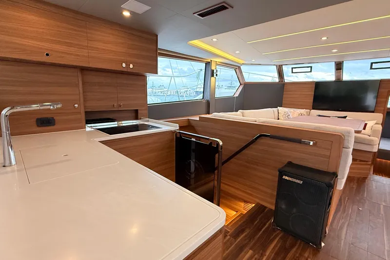  Yacht Photos Pics Luxurious interior of 2025 Aquila 50 Yacht with modern kitchen and spacious seating area.