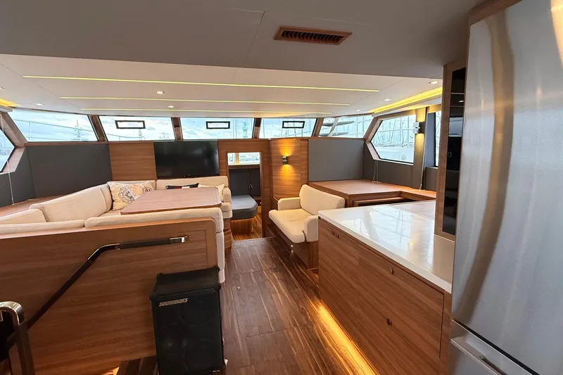  Yacht Photos Pics Luxurious interior of 2025 Aquila 50 Yacht with modern wood finishes and spacious seating.