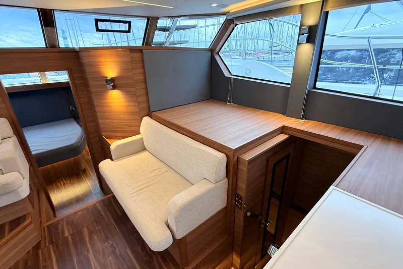  Yacht Photos Pics Luxurious interior of 2025 Aquila 50 Yacht with modern wood finishes and seating.