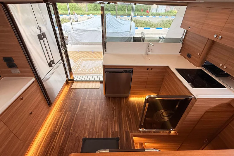  Yacht Photos Pics Modern kitchen interior of 2025 Aquila 50 Yacht with wood finish and sleek appliances.