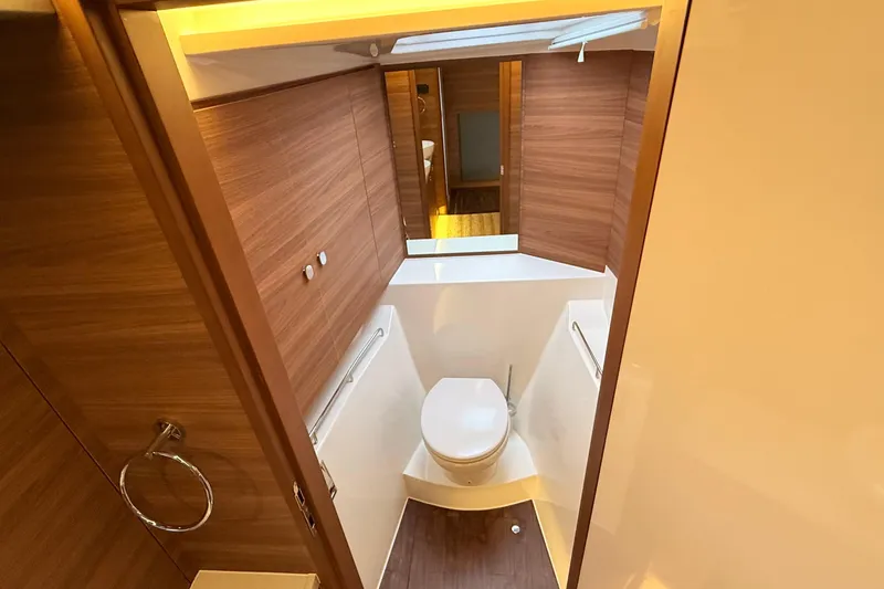  Yacht Photos Pics Modern bathroom interior on 2025 Aquila 50 Yacht, featuring wood paneling and sleek design.