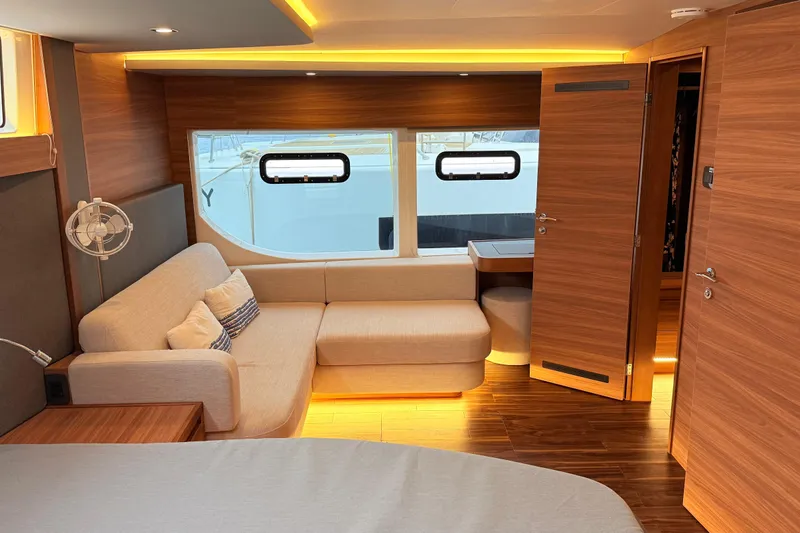  Yacht Photos Pics Luxurious interior of 2025 Aquila 50 Yacht with modern wood finish and cozy seating.