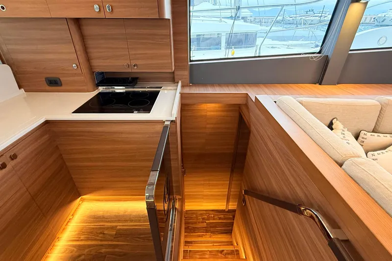  Yacht Photos Pics Luxurious interior of 2025 Aquila 50 Yacht with modern kitchen and cozy seating area.