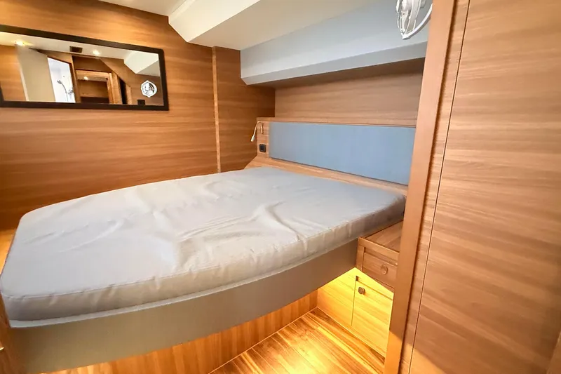  Yacht Photos Pics Luxurious cabin interior of 2025 Aquila 50 Yacht with modern wood finish.