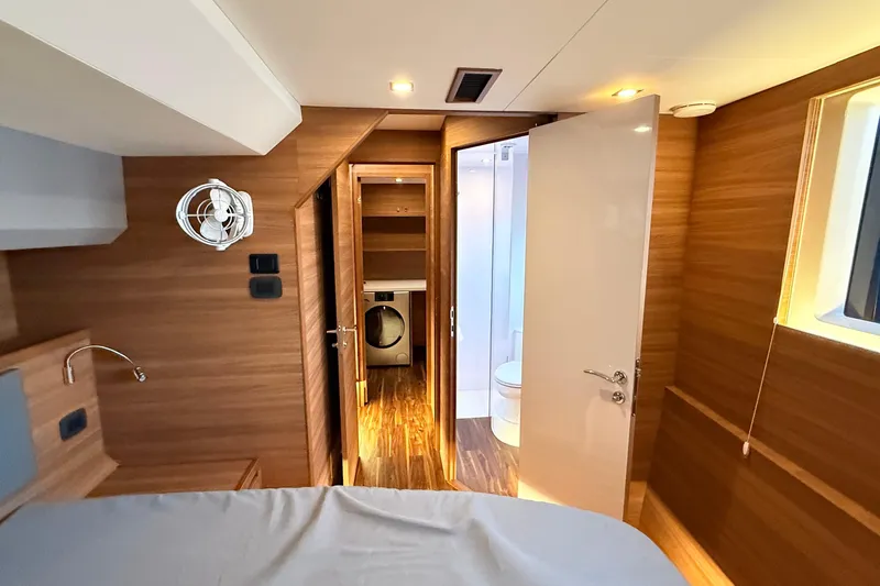  Yacht Photos Pics Interior of 2025 Aquila 50 Yacht featuring modern wood finish and ensuite bathroom.