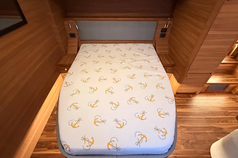 Yacht Photos Pics Luxurious cabin interior of 2025 Aquila 50 Yacht with anchor-patterned bedding.