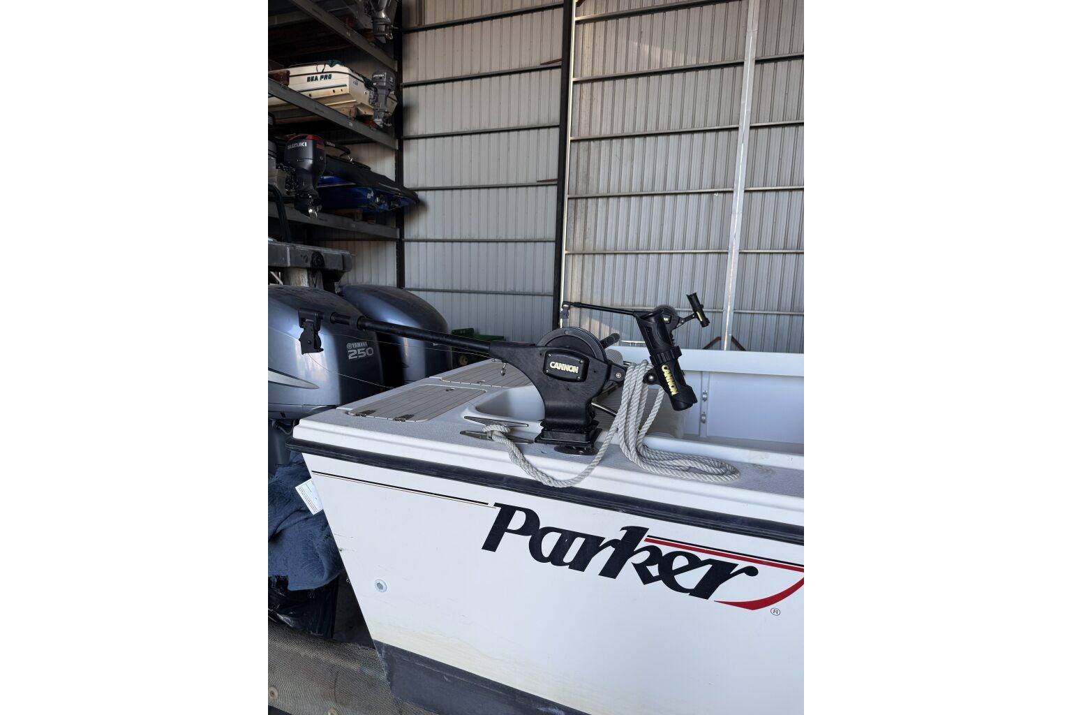 2006 Parker 2820 XL Sport Cabin boat with fishing equipment in storage.