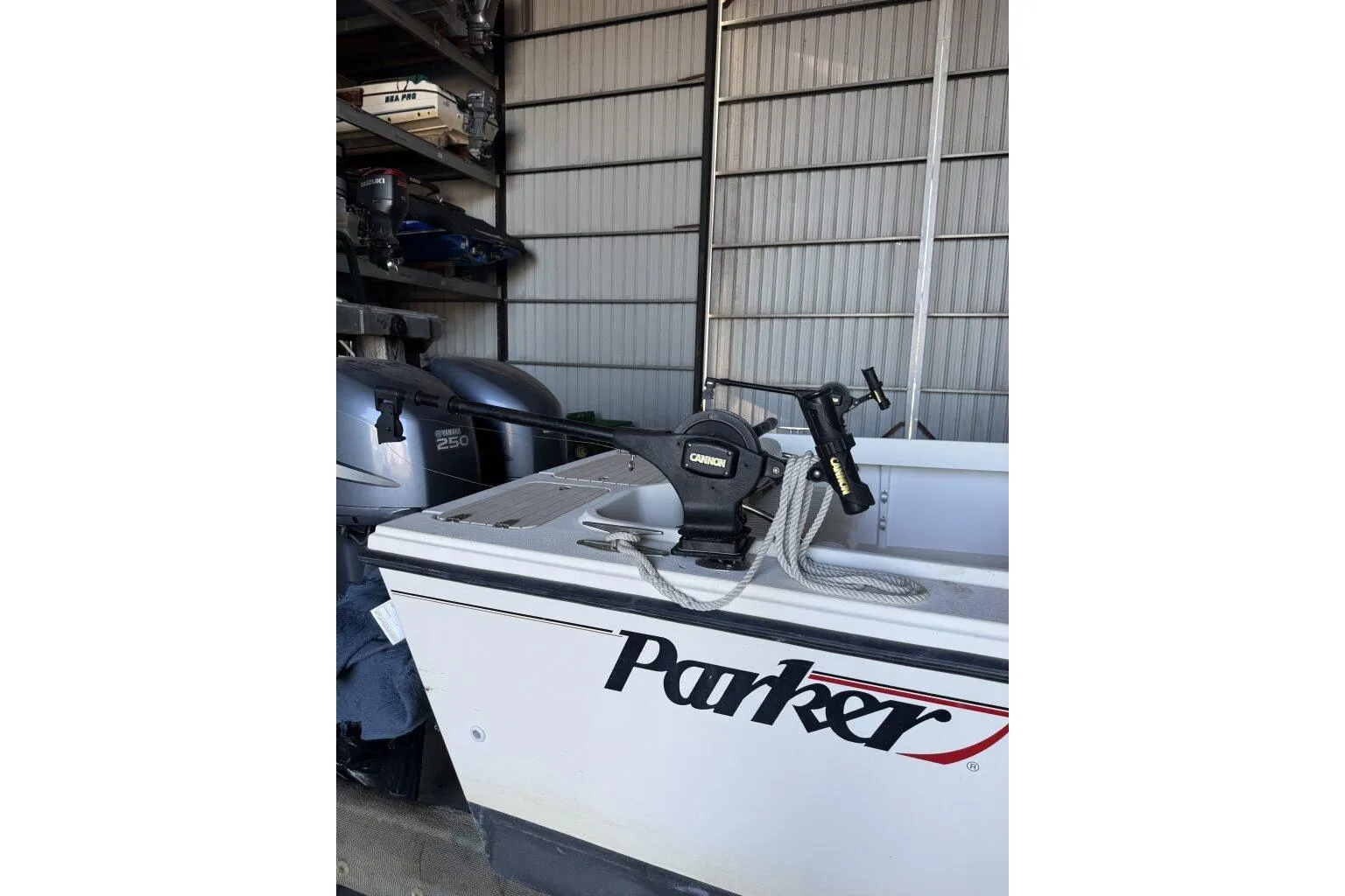 2006 Parker 2820 XL Sport Cabin boat with fishing equipment in storage.