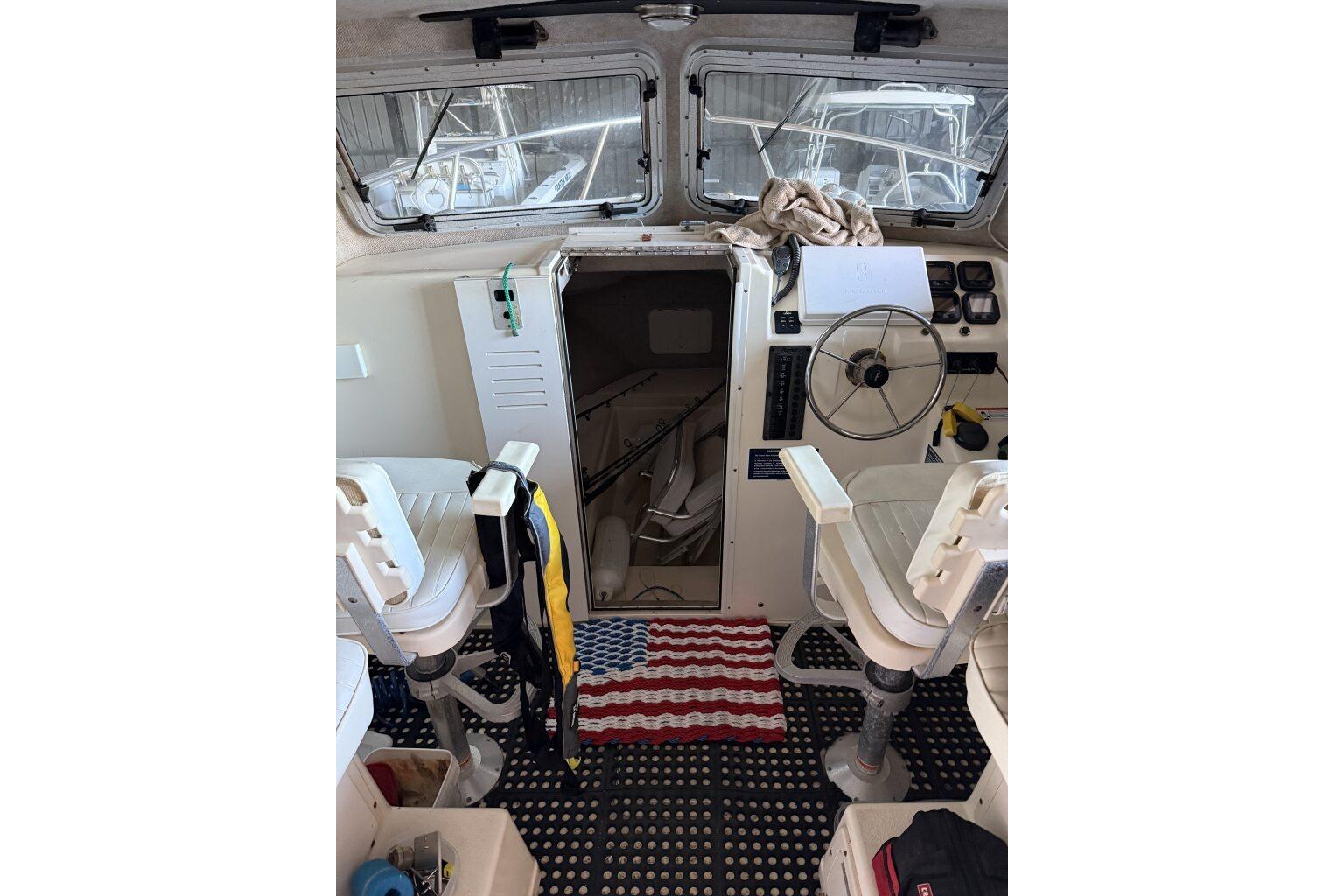 Interior of a 2006 Parker 2820 XL Sport Cabin boat with steering wheel and seating.