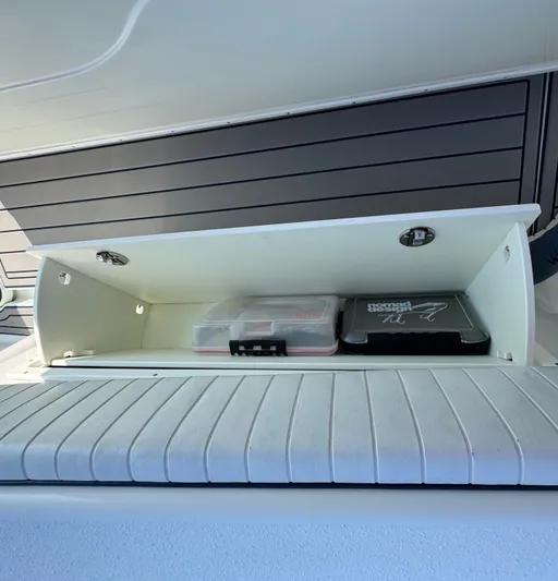 Four Boys Yacht Photos Pics Storage compartment on a 2014 Yellowfin 36 boat with organized tackle boxes.