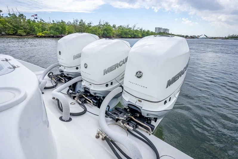  Yacht Photos Pics Triple Mercury outboard engines on a 2018 Yellowfin 39 Offshore boat, docked by the water.