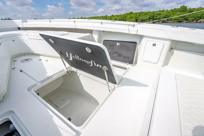  Yacht Photos Pics 2018 Yellowfin 39 Offshore boat with open storage compartment, white deck, and scenic background.