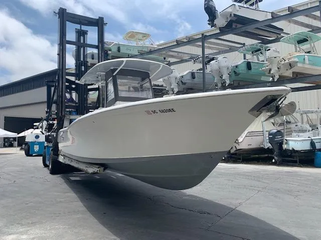  Yacht Photos Pics 2014 Sea Hunt Gamefish 30 boat on forklift at marina storage facility.