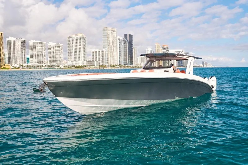  Yacht Photos Pics Luxury Midnight Express 43 Open boat cruising near city skyline on a sunny day.