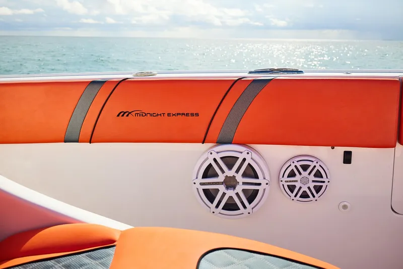  Yacht Photos Pics Midnight Express 43 Open boat interior with orange seating and audio speakers, ocean view.