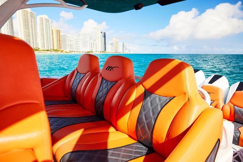  Yacht Photos Pics Luxurious orange seats on a Midnight Express 43 Open boat with city skyline view.