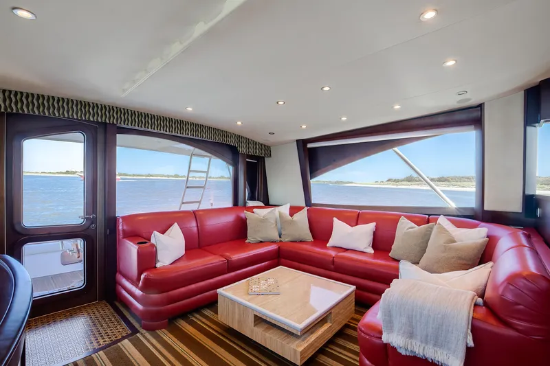 Love Boat Yacht Photos Pics Luxurious interior of 2015 Ocean Yachts 64 Convertible with red leather seating and ocean view.