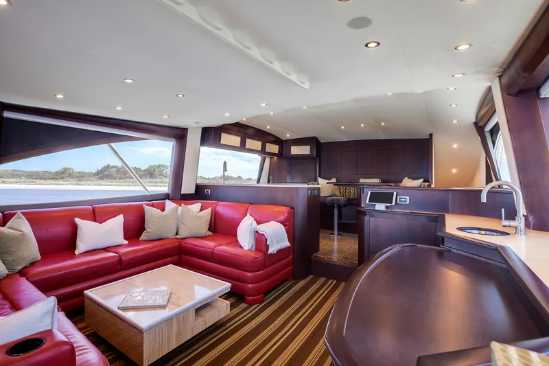 Love Boat Yacht Photos Pics Luxurious interior of 2015 Ocean Yachts 64 Convertible with red seating and modern amenities.