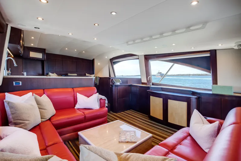 Love Boat Yacht Photos Pics Luxurious interior of 2015 Ocean Yachts 64 Convertible with red leather seating and ocean view.