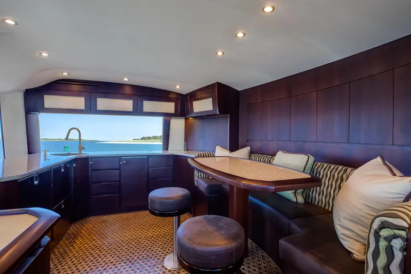 Love Boat Yacht Photos Pics Luxurious interior of 2015 Ocean Yachts 64 Convertible with elegant seating and ocean view.