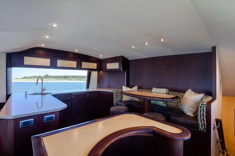 Love Boat Yacht Photos Pics Luxurious interior of 2015 Ocean Yachts 64 Convertible with elegant seating and ocean view.