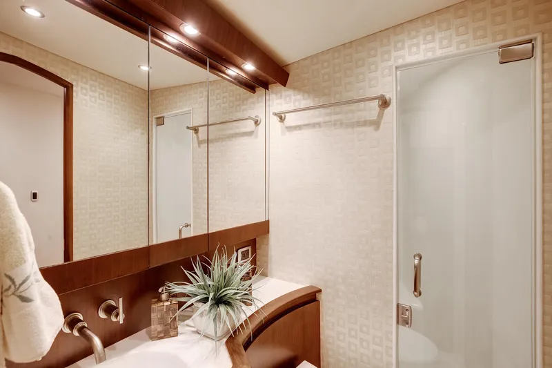 Love Boat Yacht Photos Pics Luxurious bathroom interior of 2015 Ocean Yachts 64 Convertible, featuring elegant fixtures and modern design.