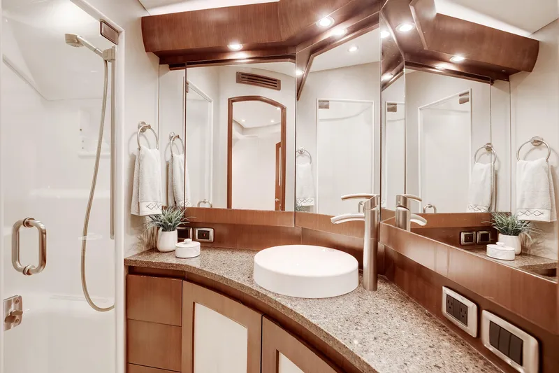 Love Boat Yacht Photos Pics Luxurious bathroom in 2015 Ocean Yachts 64 Convertible, featuring modern fixtures and elegant design.