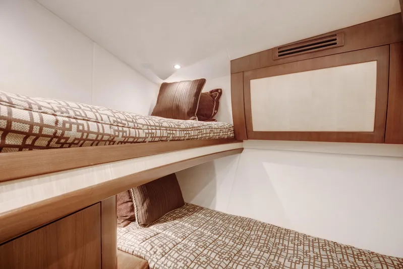Love Boat Yacht Photos Pics Bunk beds in 2015 Ocean Yachts 64 Convertible, featuring modern design and cozy bedding.