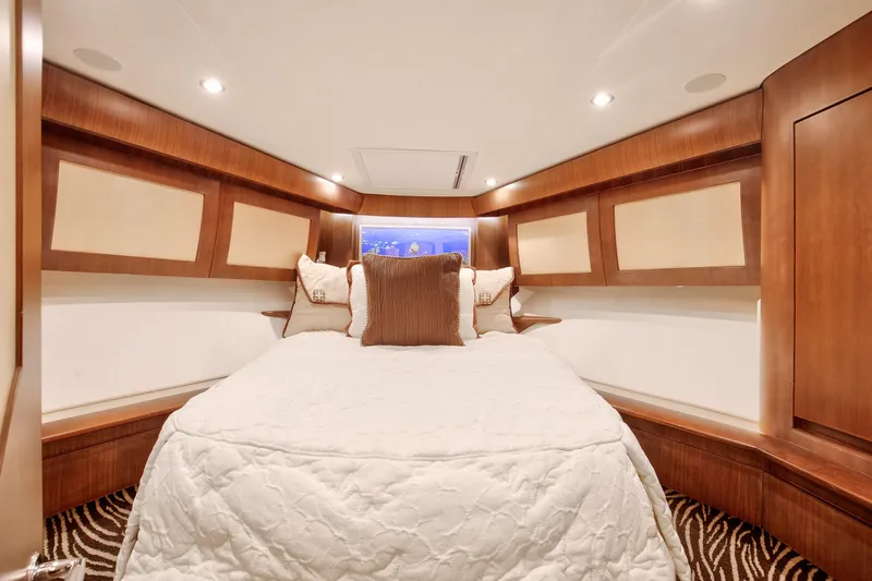 Love Boat Yacht Photos Pics Luxurious bedroom interior of 2015 Ocean Yachts 64 Convertible with elegant wood finishes.
