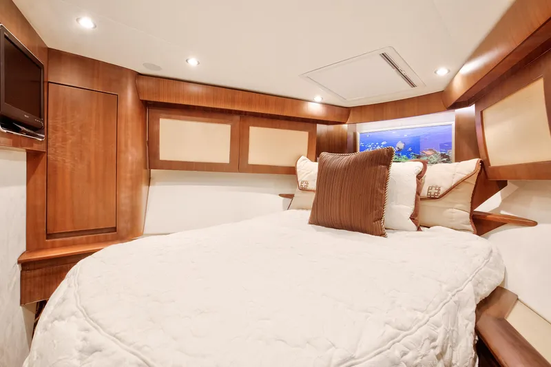 Love Boat Yacht Photos Pics Luxurious bedroom interior of 2015 Ocean Yachts 64 Convertible with elegant wood finishes.