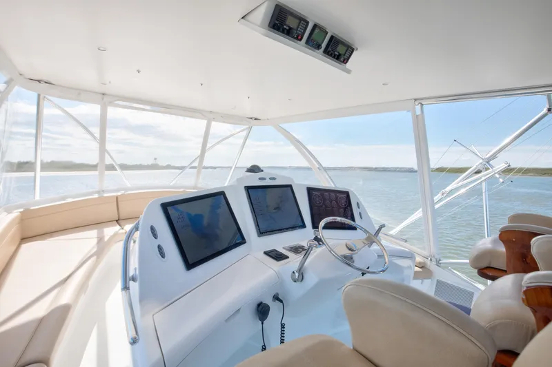 Love Boat Yacht Photos Pics Luxurious helm of 2015 Ocean Yachts 64 Convertible with modern navigation displays.