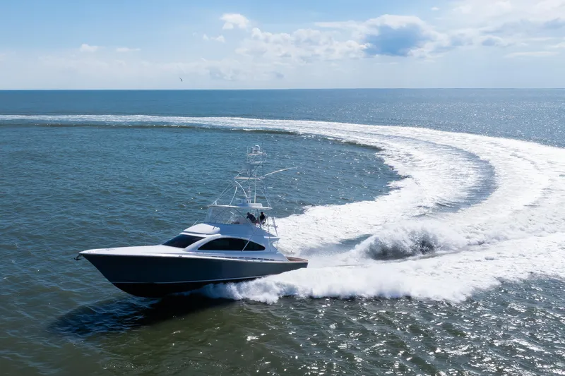 Love Boat Yacht Photos Pics 2015 Ocean Yachts 64 Convertible cruising on open sea, creating a dynamic water trail.