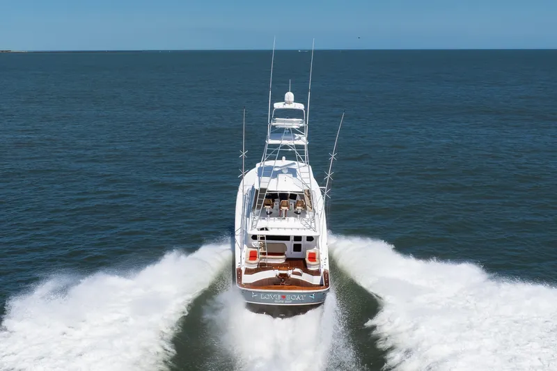 Love Boat Yacht Photos Pics 2015 Ocean Yachts 64 Convertible cruising on open sea, rear view.