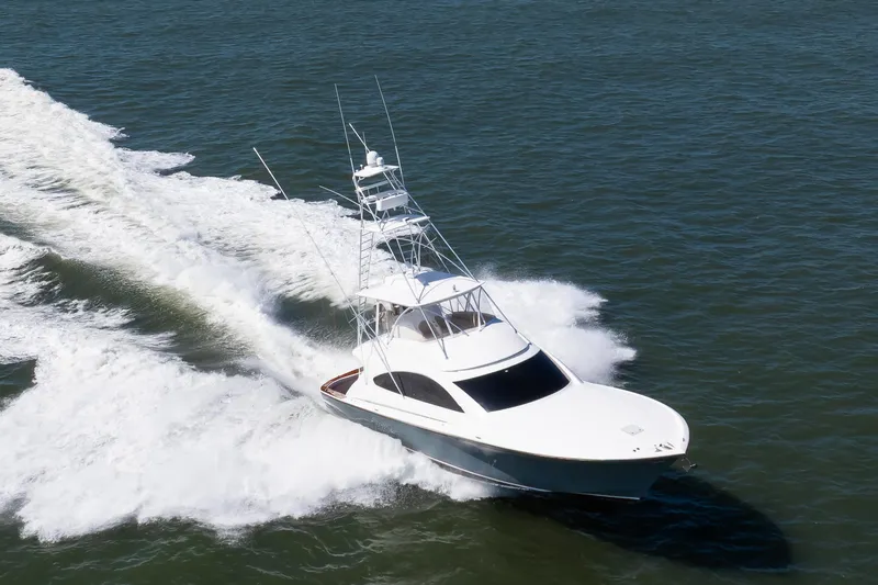 Love Boat Yacht Photos Pics 2015 Ocean Yachts 64 Convertible cruising on open water, creating a dynamic wake.