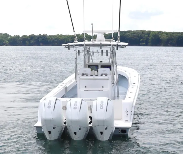  Yacht Photos Pics 2022 Contender 35 ST boat with triple outboard engines on a calm lake.