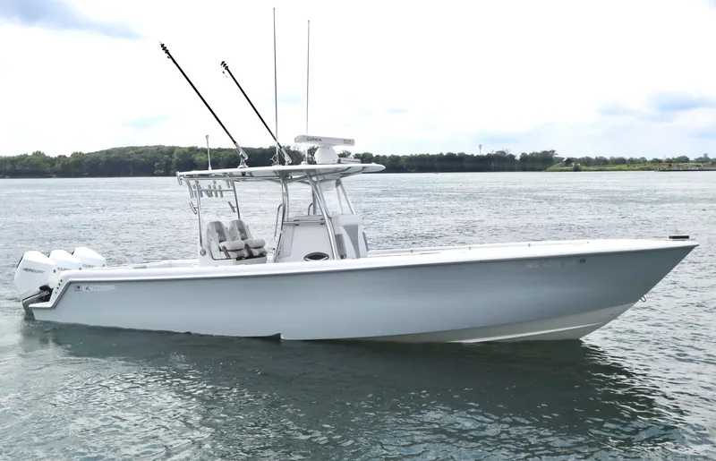  Yacht Photos Pics 2022 Contender 35 ST boat on calm water, featuring sleek design and fishing equipment.