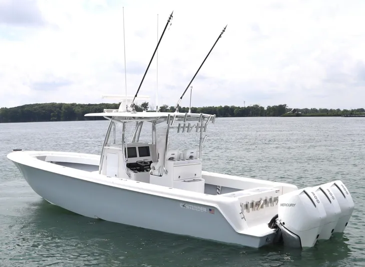  Yacht Photos Pics 2022 Contender 35 ST boat with triple Mercury engines on calm water.