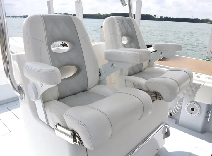  Yacht Photos Pics Luxury seating on 2022 Contender 35 ST boat, featuring plush white upholstery and armrests.