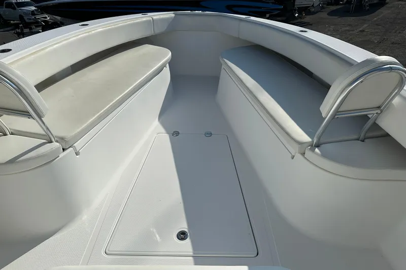  Yacht Photos Pics 2013 Bahama 37CC boat interior with white cushioned seating and storage compartment.