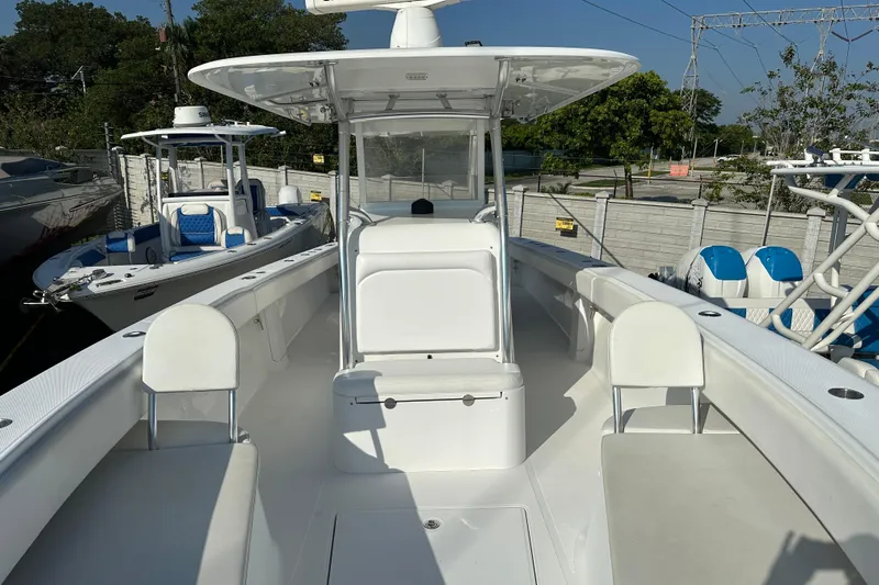  Yacht Photos Pics 2013 Bahama 37CC boat with white seating and console, docked outdoors.