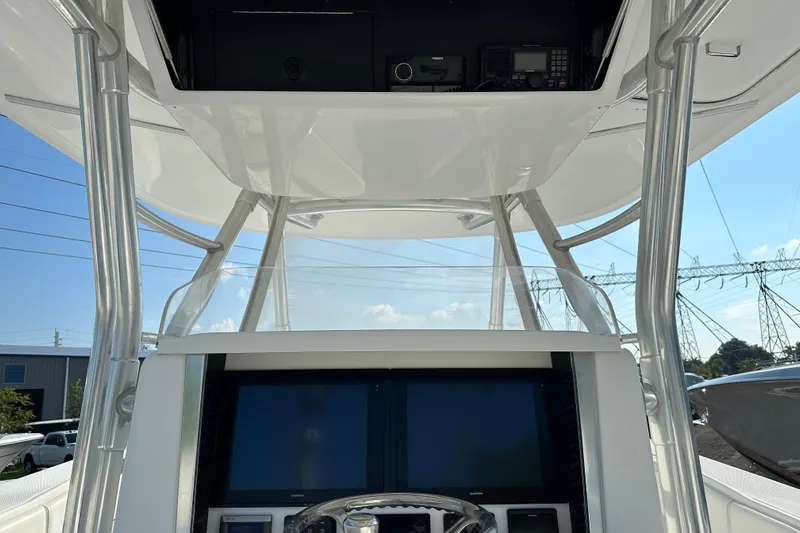  Yacht Photos Pics 2013 Bahama 37CC boat helm with electronics and overhead storage.