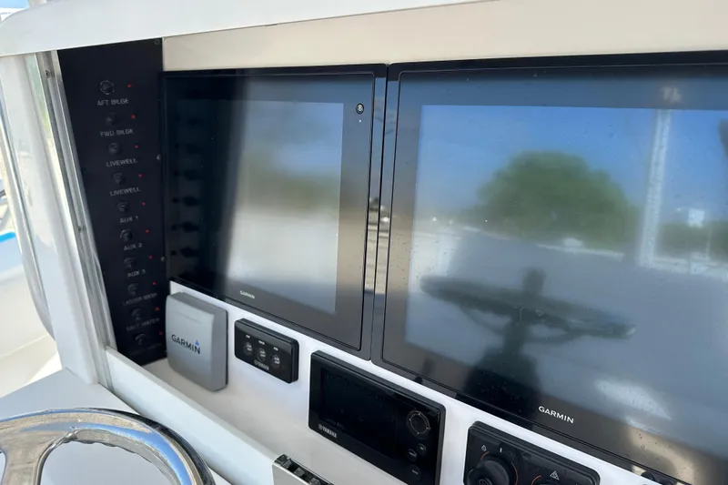  Yacht Photos Pics 2013 Bahama 37CC boat dashboard with Garmin navigation screens and control panel.