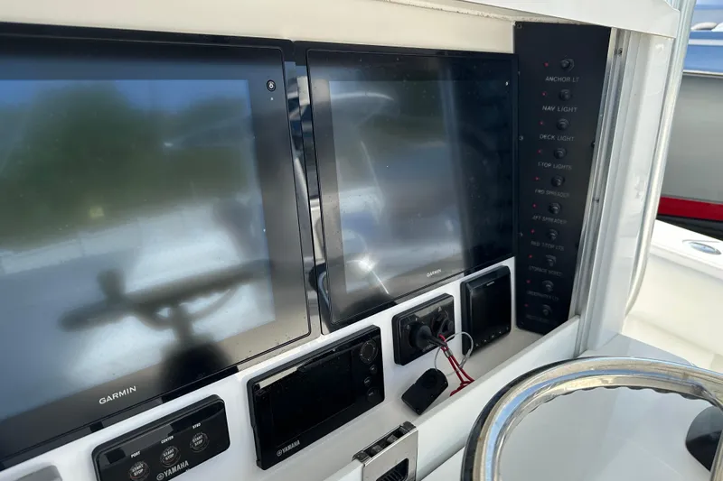  Yacht Photos Pics Control panel of a 2013 Bahama 37CC boat with Garmin displays and Yamaha controls.