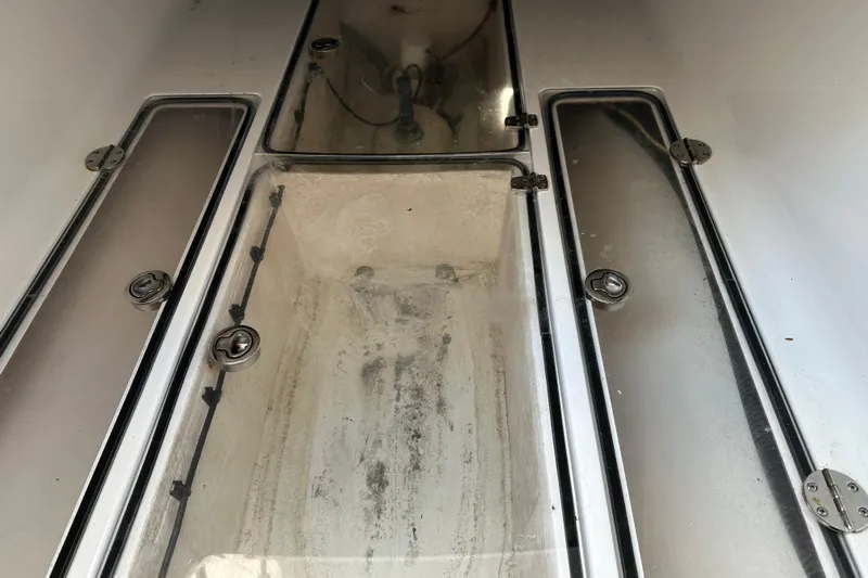  Yacht Photos Pics 2013 Bahama 37CC boat storage compartments with secure latches and clean interior.