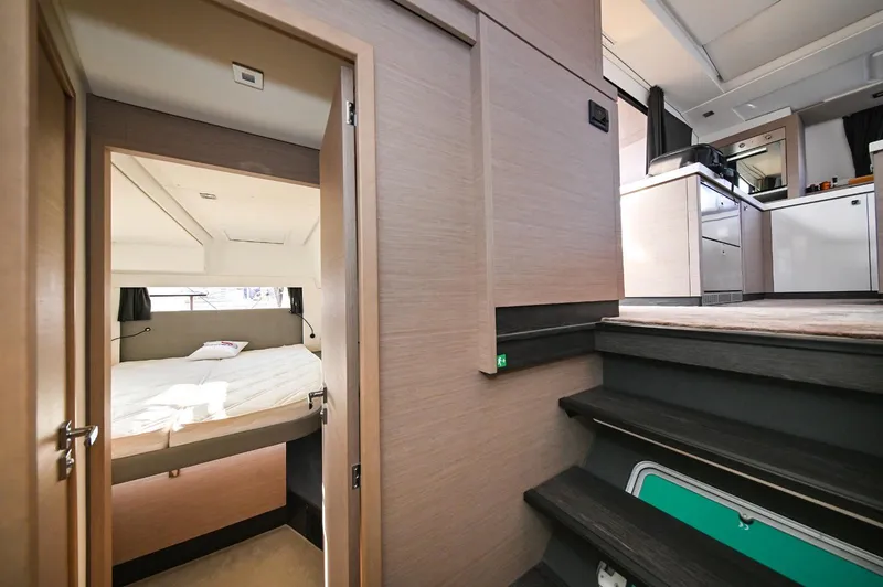 Pandora Yacht Photos Pics Interior of 2019 Fountaine Pajot Saona 47 catamaran, featuring bedroom and modern kitchen.