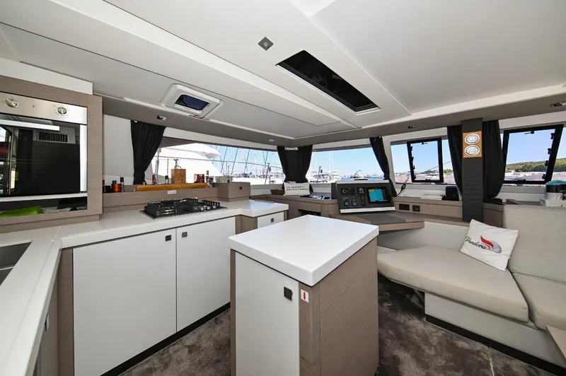 Pandora Yacht Photos Pics Modern interior of 2019 Fountaine Pajot Saona 47 catamaran with sleek kitchen and seating area.