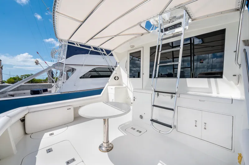 50 Hatteras Convertible Yacht Photos Pics 1992 Hatteras 50 Convertible yacht deck with seating, table, and ladder.