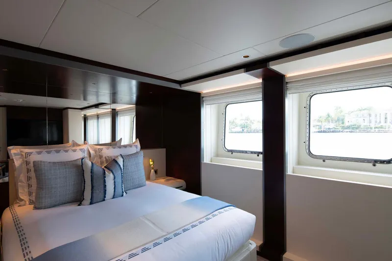 Book Ends Yacht Photos Pics Luxurious bedroom interior of 2022 Heesen 5000 yacht with elegant bedding and large windows.