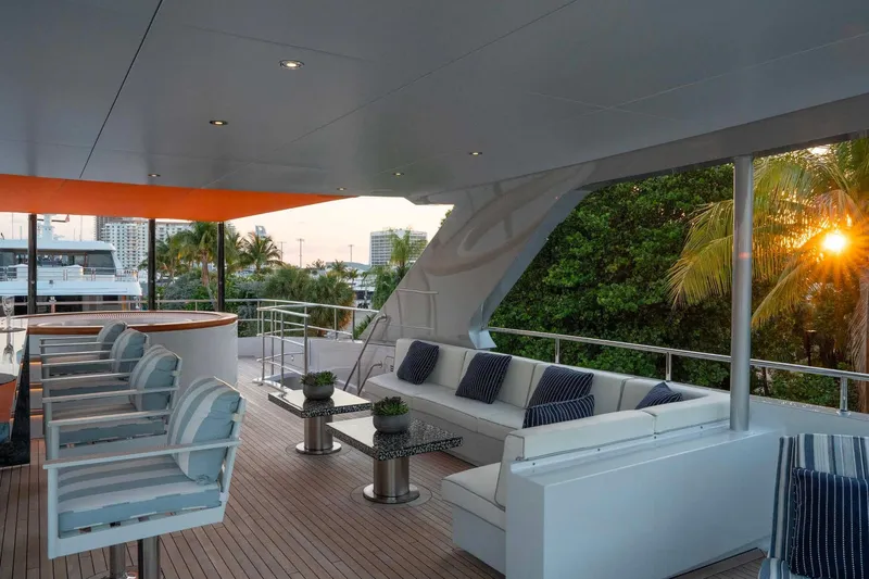 Book Ends Yacht Photos Pics Luxurious 2022 Heesen 5000 yacht deck with elegant seating and sunset view.