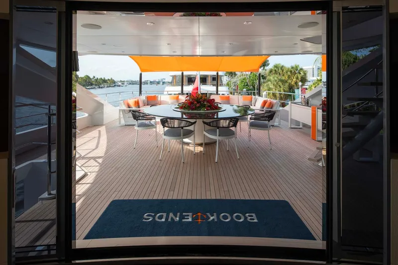 Book Ends Yacht Photos Pics Luxurious 2022 Heesen 5000 yacht deck with elegant seating and vibrant decor.